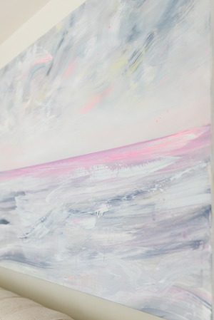 Close up detail of an abstract ocean landscape painting, above a queen sized bed. 